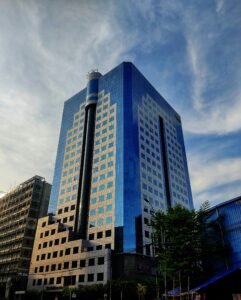 Tall modern skyscraper in Dhaka, showcasing sleek glass architecture.